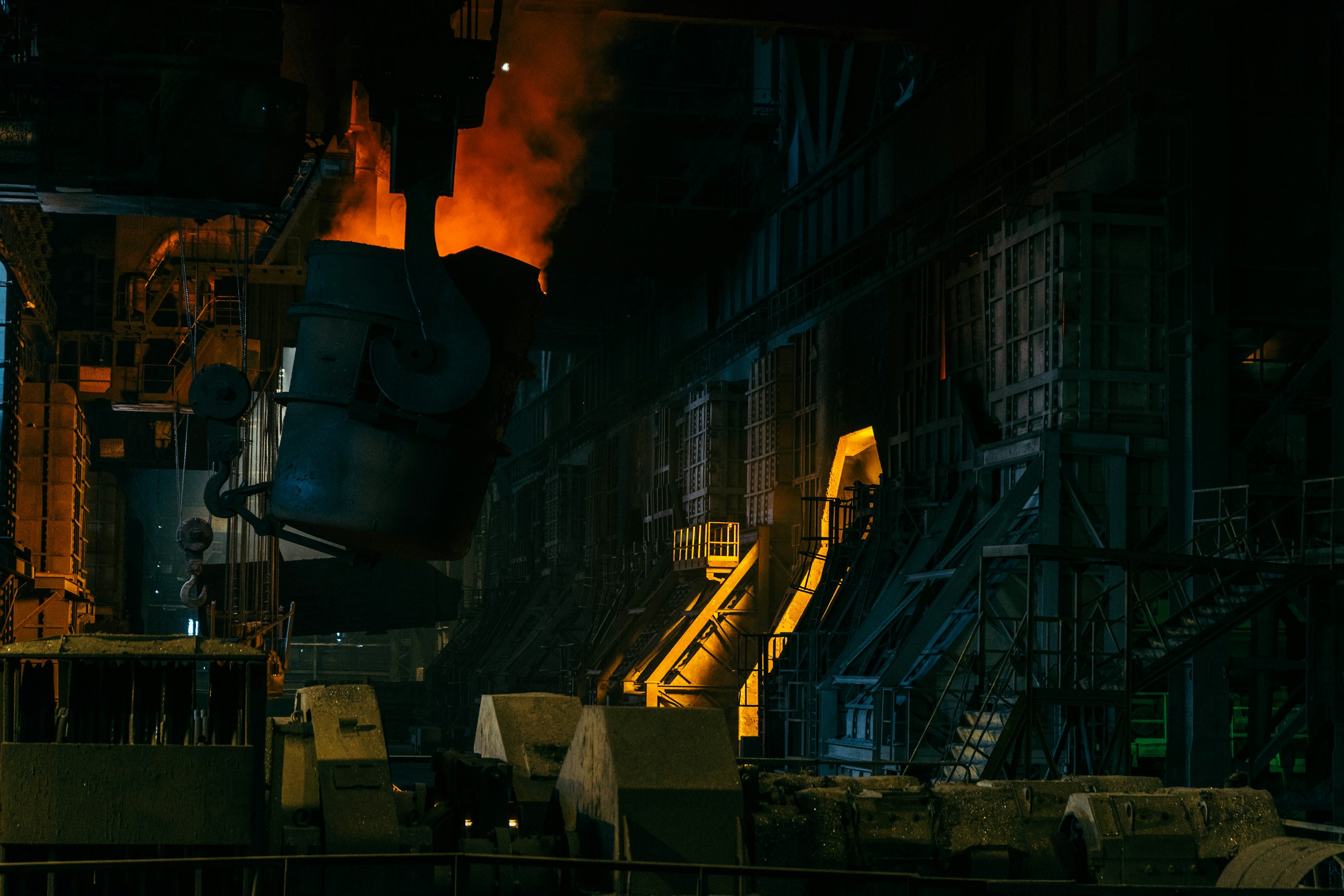 Steel mill interior with heavy processing equipment — industrial wastewater context. Photo: Ant Rozetsky on Unsplash.