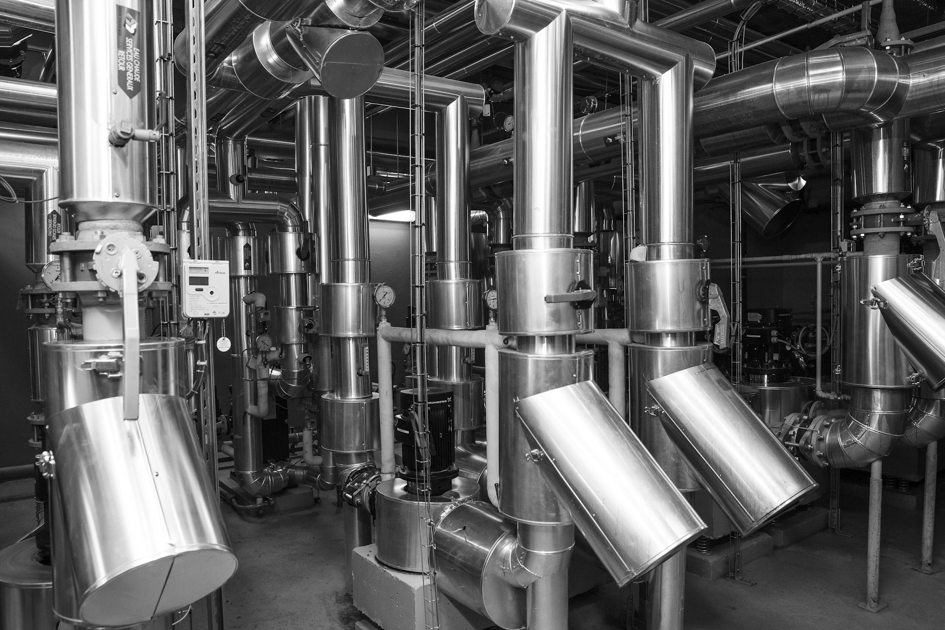 Industrial piping and machinery inside a process facility — ETP and plant integration context. Photo: Lionel SEE on Unsplash.